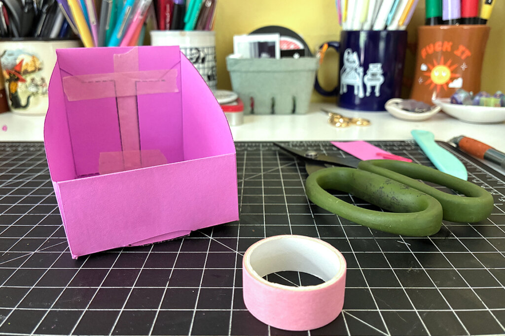 The zine holder washi-taped together.