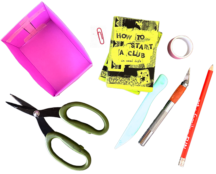 A pink paper zine holder, a paper clip, a stack of mini zines, washi tape, a bone folder, an exacto knife, a pencil, scissors